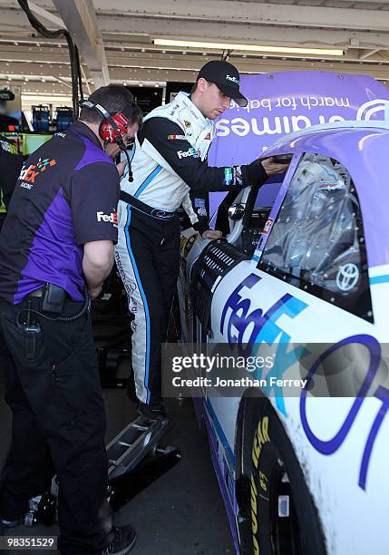 Denny Hamlin, driver of the FedEx Office/March of DimesToyota, climbs into his car during practice for the NASCAR Sprint Cup Series Subway Fresh Fit...