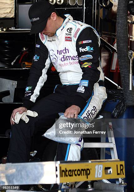 Denny Hamlin, driver of the FedEx Office/March of DimesToyota, ices his left knee during practice for the NASCAR Sprint Cup Series Subway Fresh Fit...