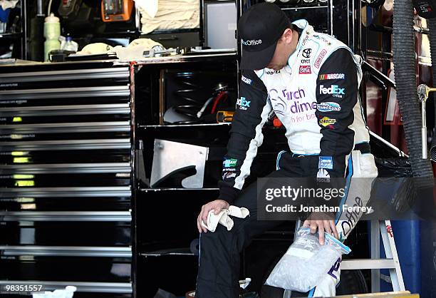 Denny Hamlin, driver of the FedEx Office/March of DimesToyota, ices his left knee during practice for the NASCAR Sprint Cup Series Subway Fresh Fit...
