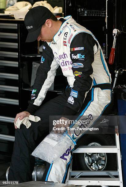 Denny Hamlin, driver of the FedEx Office/March of DimesToyota, ices his left knee during practice for the NASCAR Sprint Cup Series Subway Fresh Fit...