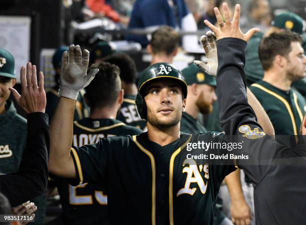 Matt Olson of the Oakland Athletics is greeted after hitting a home run against the Chicago White Sox during the sixth inning in game two of a...