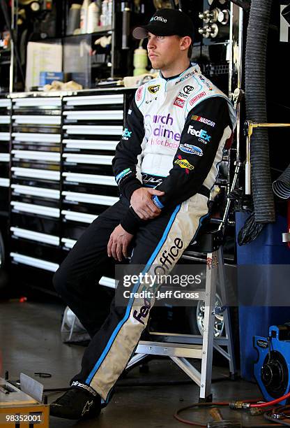 Denny Hamlin, driver of the FedEx Office/March of DimesToyota, looks on from the garage during practice for the NASCAR Sprint Cup Series Subway Fresh...