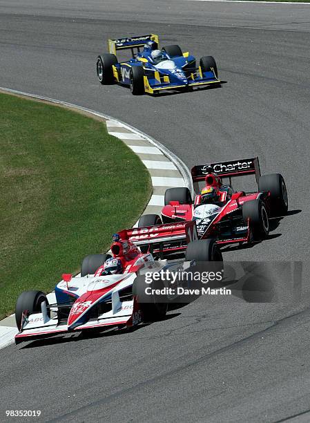 Vitor Meira of Brazil leads Justin Wilson of England and Mike Conway of England thru turn two during practice for the IRL IndyCar Series Grand Prix...