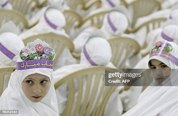 Lebanese Shiite Muslim girls takes part in a complete headdress or "hijab" ceremony at an Al-Mahdi School in southern Beirut on April 9, 2010. Around...