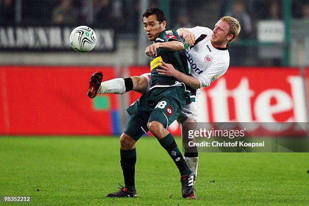 Patrick Ochs of Frankfurt challenges Juan Arango of Gladbach during the Bundesliga match between Borussia Moenchengladbach and Eintracht Frankfurt at...