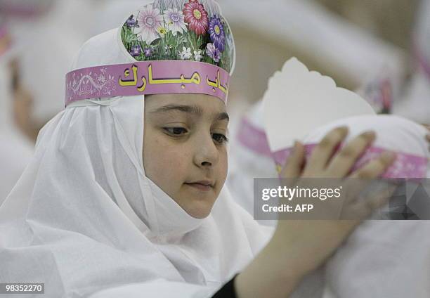 Lebanese Shiite Muslim girls takes part in a complete headdress or "hijab" ceremony at an Al-Mahdi School in southern Beirut on April 9, 2010. Around...