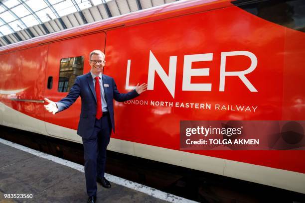 London North Eastern Railway Managing Directer, David Horne, poses with an LNER train at King's Cross rail station in London on June 25 during a...