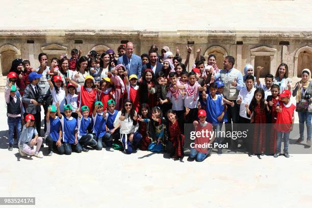 Prince William, Duke of Cambridge and Crown Prince Hussein of Jordan pose for a group photo with children from the Makani Centre, a free education...