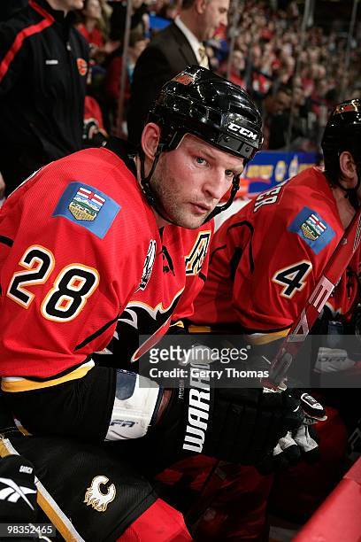 Robyn Regehr of the Calgary Flames sits on the bench in between shifts against the Phoenix Coyotes on March 31, 2010 at Pengrowth Saddledome in...