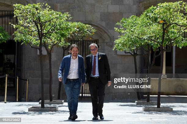 Catalan regional president Quim Torra and left-wing party Podemos leader, Pablo Iglesias walk together before a meeting on June 25, 2018 at Palau de...