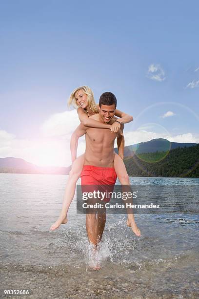 a boy carrying a girl - hot boy body stock pictures, royalty-free photos & images