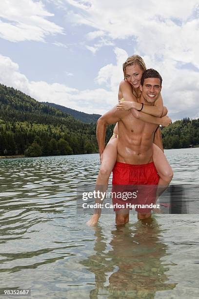 a boy carrying a girl - hot boy body stock pictures, royalty-free photos & images