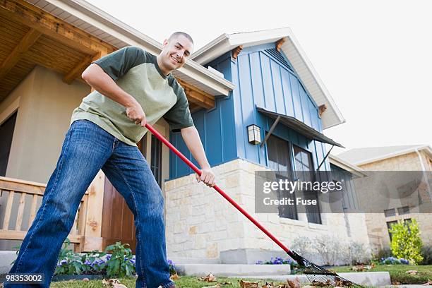 man raking leaves - man raking leaves stock pictures, royalty-free photos & images