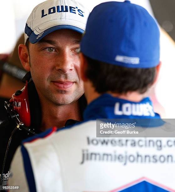 Chad Knaus , crew chief for the Lowe's Chevrolet, talks with driver Jimmie Johnson in the garage during practice for the NASCAR Sprint Cup Series...