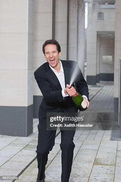 businessman splashing champagne - spraying champagne stock pictures, royalty-free photos & images