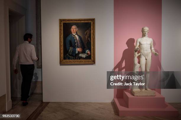 Gallery worker walks out of a room beside 'Ritratto di William Rouet, precettore della famiglia Hope', by Louis Gabriel Blanchet and a marble statue...