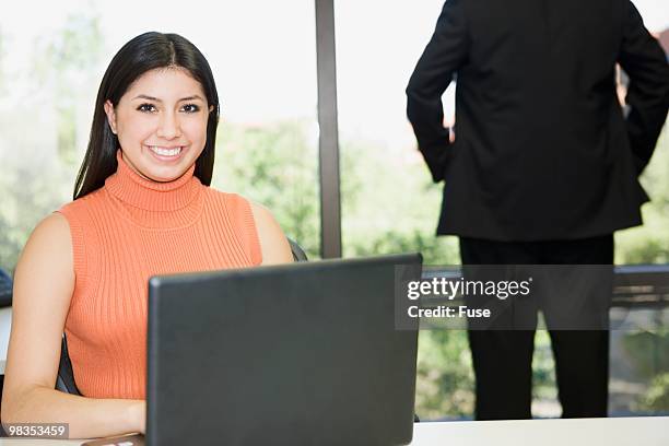 businesswoman using a laptop - lower employee engagement stock pictures, royalty-free photos & images