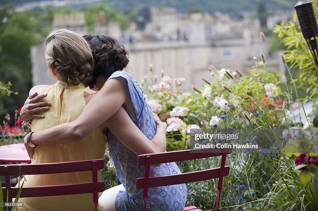 Two women hugging on balcony