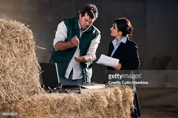 business woman advising farmer - man check suit stock pictures, royalty-free photos & images