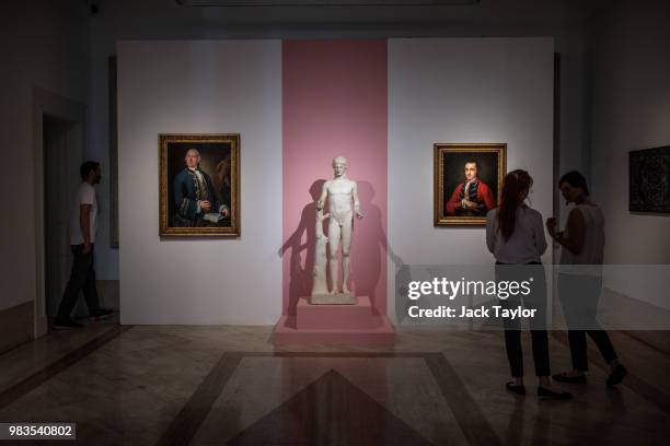 Gallery workers stand in front of 'Ritratto di William Rouet, precettore della famiglia Hope', by Louis Gabriel Blanchet, a marble statue titled 'The...