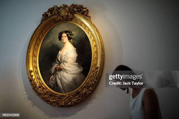 Gallery worker passes 'A Portrait of A Lady, Therese Freifrau Von Bethmann, nee Freiin Vrints V Treuenfeld by Franz Xaver Winterhalter at the...