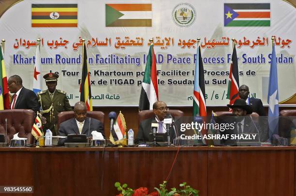 From left to right, Ugandan President Yoweri Museveni, Sudanese President Omar al-Bashir and South Sudanese President Salva Kiir, participate in a...