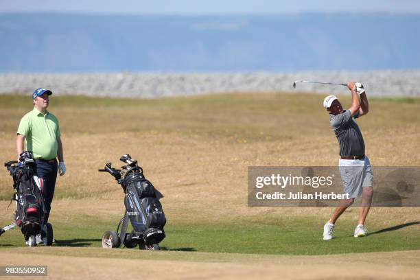 Robert Selley of Teignmouth Golf Club watches as his partner Alan Plunkett plays a shot during The Lombard Trophy South West Qualifier at Royal North...