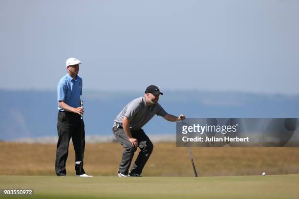 Graham Howell of Ferndown Forest Golf Club watches as his partner Dave Austin plays a shot during The Lombard Trophy South West Qualifier at Royal...