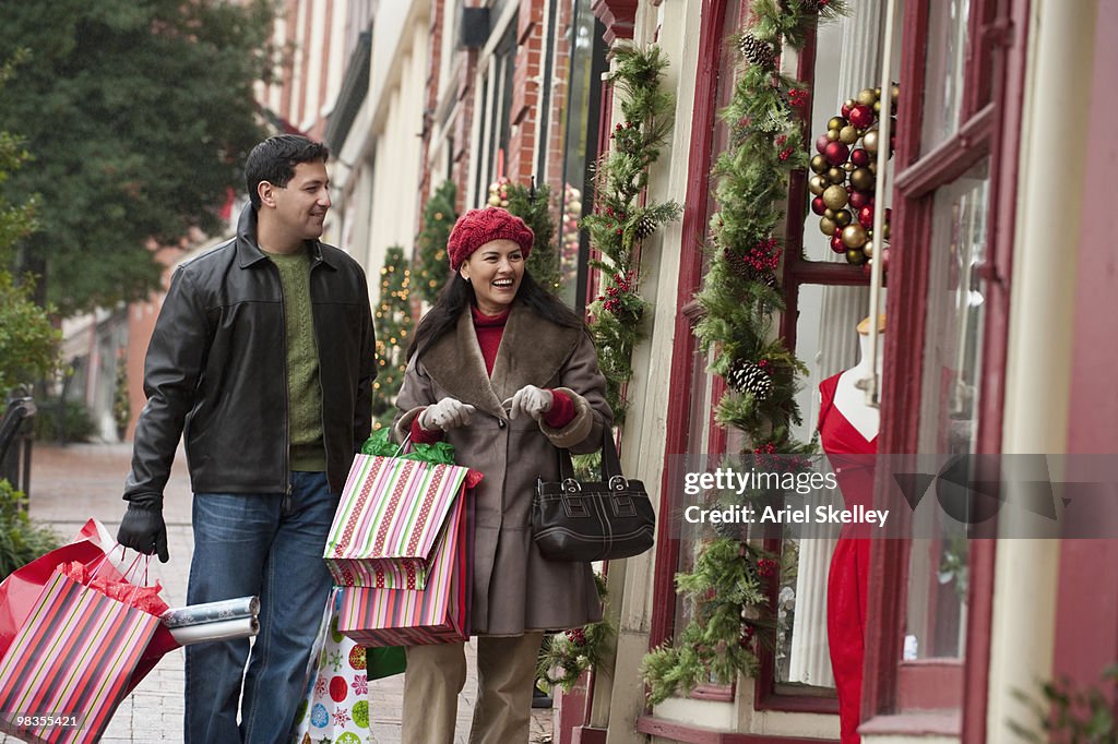 Hispanic couple shopping at Christmas