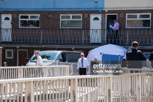 Police investigate at the scene of where a man died and two other men suffered life-threatening injuries after a burglary in Prewett Street,...