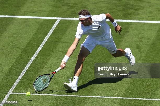 Denis Istomin of Uzbekistan in action against Andreas Speppi of Italy during Day four of the Nature Valley International at Devonshire Park on June...