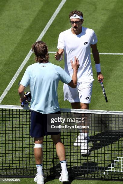 Denis Istomin of Uzbekistan shakes hands with Andreas Seppi of Italy after beating him during Day four of the Nature Valley International at...