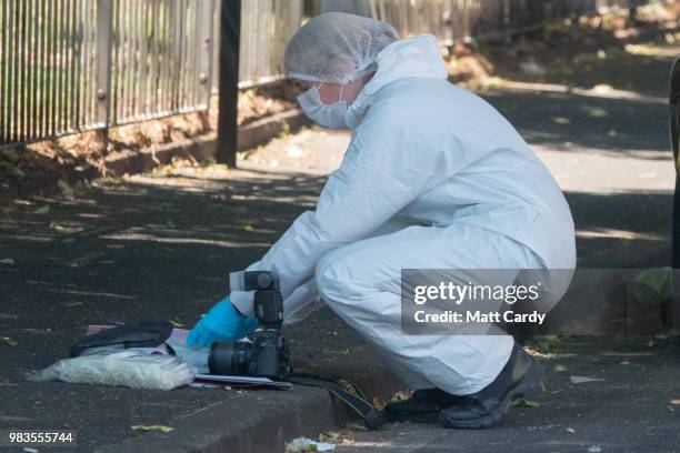 Police investigate at the scene of where a man died and two other men suffered life-threatening injuries after a burglary in Prewett Street,...