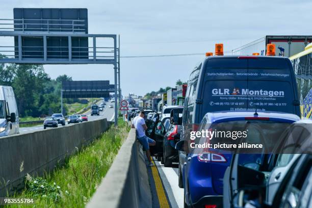 June 2018, Berlin, Germany: Cars and trucks are standing in the congestion area on the motorway A10 in the traffic jam after an accident on the...