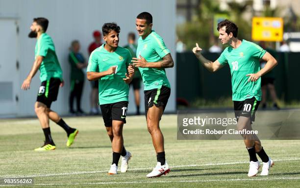 Daniel Arzani, Tim Cahill, and Robbie Kruse of Australia speak during a training session during an Australian Socceroos media opportunity at Park...