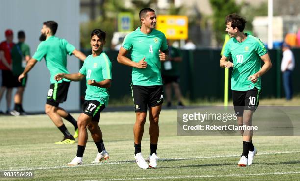 Daniel Arzani, Tim Cahill, and Robbie Kruse of Australia speak during a training session during an Australian Socceroos media opportunity at Park...