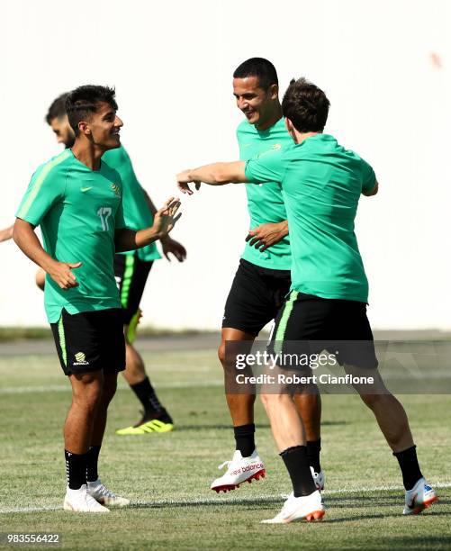 Daniel Arzani, Tim Cahill, and Robbie Kruse of Australia speak during a training session during an Australian Socceroos media opportunity at Park...