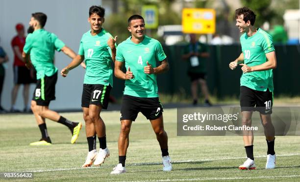 Daniel Arzani, Tim Cahill, and Robbie Kruse of Australia speak during a training session during an Australian Socceroos media opportunity at Park...