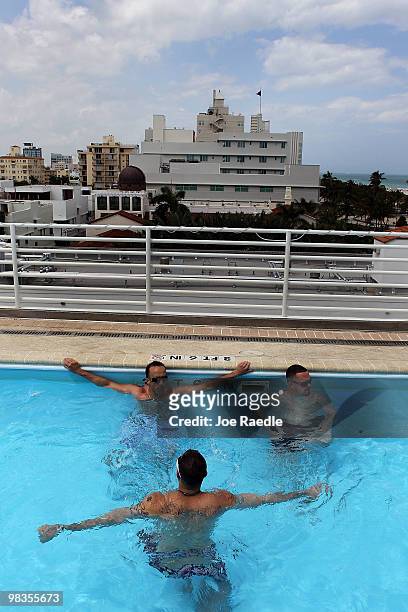 Billy Groneman, , Jay Rivera and Iam Scheinblum, on vacation from New York, relax in the pool at The Strand, Ocean Drive Hotel on April 9, 2010 in...