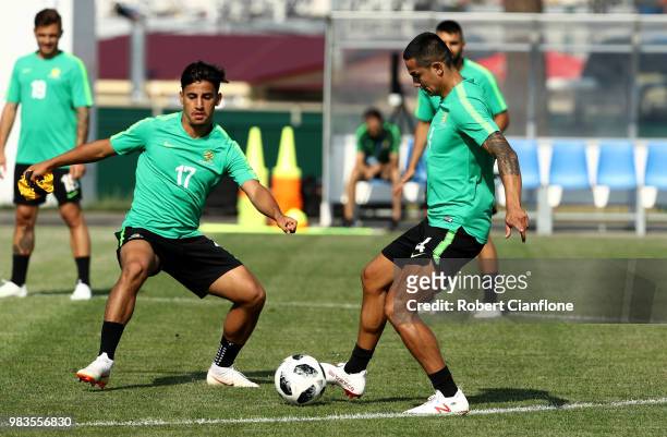 Tim Cahill of Australia is challenged by Daniel Arzani of Australia during a training session during an Australian Socceroos media opportunity at...