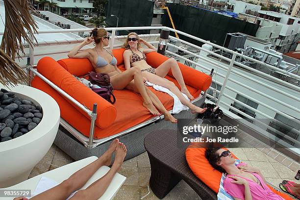 Kristen Kim , Karen Cashman and Donna Murphy , on vacation from New York, lay next to the pool at The Strand, Ocean Drive Hotel on April 9, 2010 in...