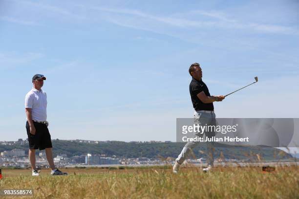James House looks on as Andy Welch of Whitsand Bay Golf Club plays a shot during The Lombard Trophy South West Qualifier at Royal North Devon Golf...
