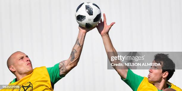 Australia's midfielder Aaron Mooy and Australia's forward Robbie Kruse vie for the ball during a training session at the Park Arena in Sochi on June...