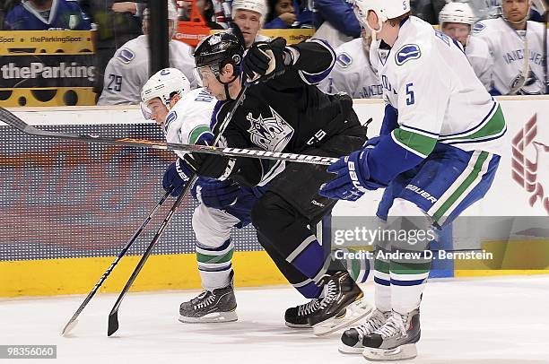 Mason Raymond and Christian Ehrhoff of the Vancouver Canucks defend against Ryan Smyth of the Los Angeles Kings on April 1, 2010 at Staples Center in...