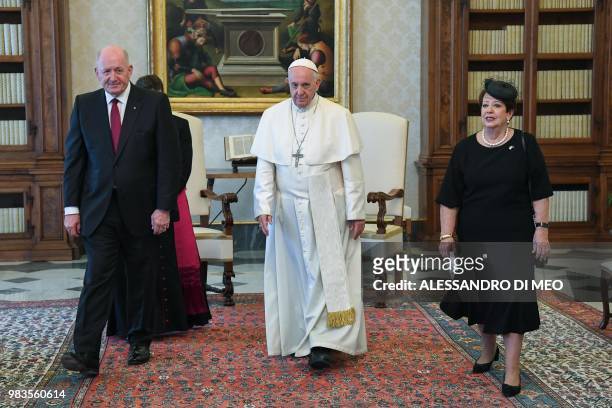 Pope Francis walks with Australian Governor General Peter Cosgrove and his wife Lynne Cosgrove during a private audience at The Vatican on June 25,...