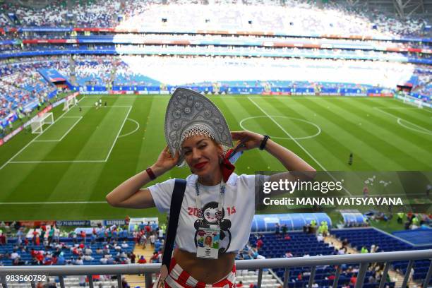 Russia's fan poses before the Russia 2018 World Cup Group A football match between Uruguay and Russia at the Samara Arena in Samara on June 25, 2018....
