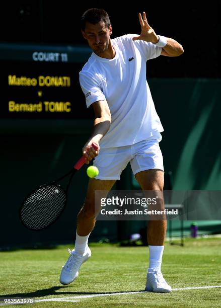 Bernard Tomic of Australia in action against Matteo Donati of Italy during the Wimbledon Lawn Tennis Championships Qualifying at The Bank of England...