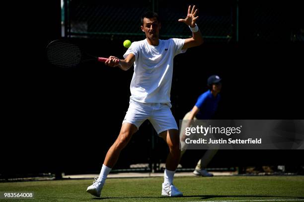 Bernard Tomic of Australia in action against Matteo Donati of Italy during the Wimbledon Lawn Tennis Championships Qualifying at The Bank of England...