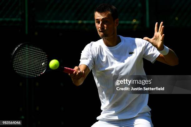 Bernard Tomic of Australia in action against Matteo Donati of Italy during the Wimbledon Lawn Tennis Championships Qualifying at The Bank of England...