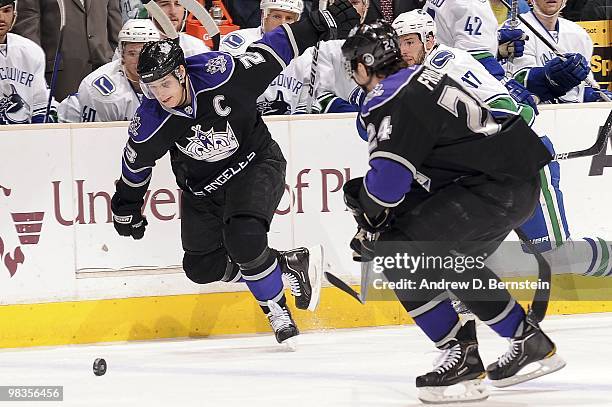 Dustin Brown and Alexander Frolov of the Los Angeles Kings defends against Ryan Kesler of the Vancouver Canucks during the game on April 1, 2010 at...